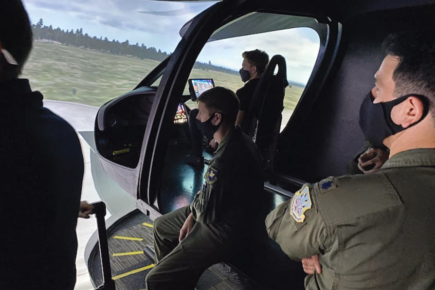 Air Force operators and engineers assess the BETA Technologies ALIA flight simulator. (Photo: BETA Technologies)
