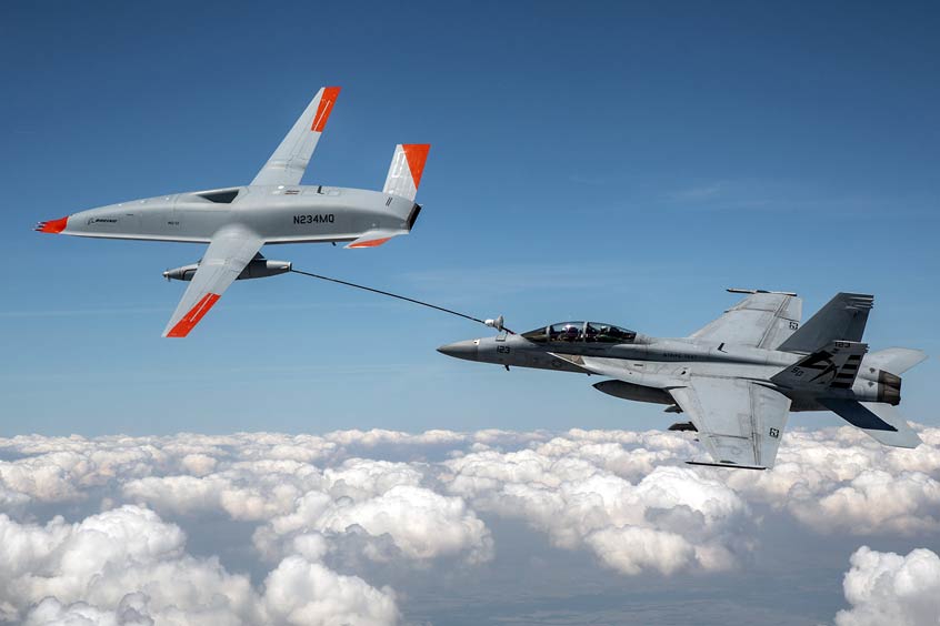 The Boeing MQ-25 T1 test asset transfers fuel to a U.S. Navy F/A-18 Super Hornet on June 4, marking the first time in history that an unmanned aircraft has refueled another aircraft. The MQ-25 Stingray will assume the carrier-based tanking role currently performed by F/A-18s, allowing for better use of the combat strike fighters and helping extend the range of the carrier air wing. (Photo: Kevin Flynn)