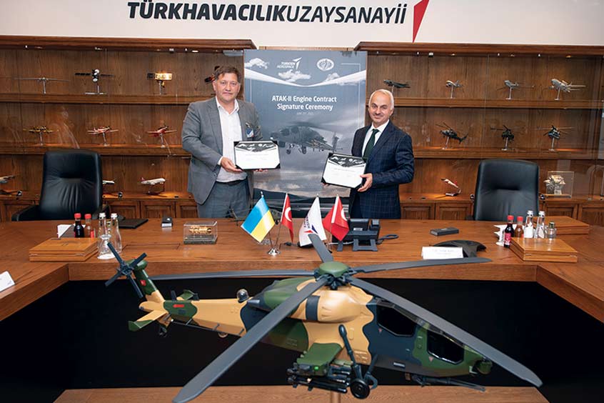 Officials sign the ATAK 2 engine contract.