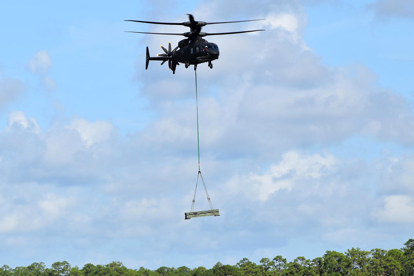 SB>1 DEFIANT demonstrates its ability to simultaneously carry troops and sling-load cargo. (Photo: Sikorsky)