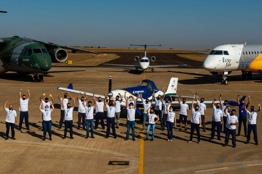 The Embraer team alongside the adapted Ipanema - with the company's more conventional product line as a backdrop.