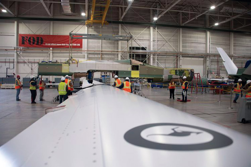 Australia’s first MQ-4C Triton fuselage is lowered onto the unique one-piece wing.