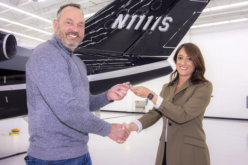 Guy Stockbridge, owner of Elite Team Offices, accepts the keys to his new M2 Gen2 from Textron Aviation Regional Sales Director Natalie Stadelman. (Photo: Textron)