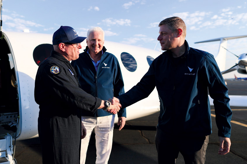 Richard F Chandler, chairman of majority Eviation shareholder Clermont Group looks on as test pilot Steve Crane shakes hands with Eviation president and CEO Greg Davis.