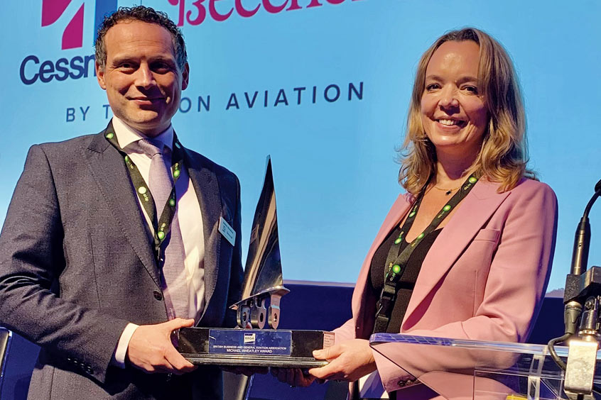 Ashley Namihas, Textron Aviation Regional Sales Director accepts the award on behalf of Tom Perry.