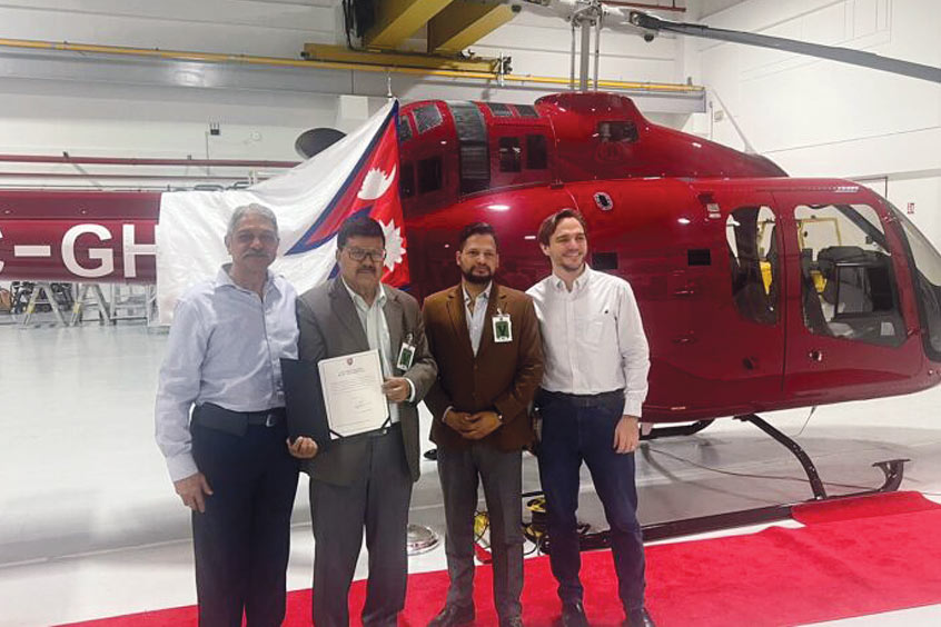 The Simrik Air team with their Bell 505 Jet Ranger X.