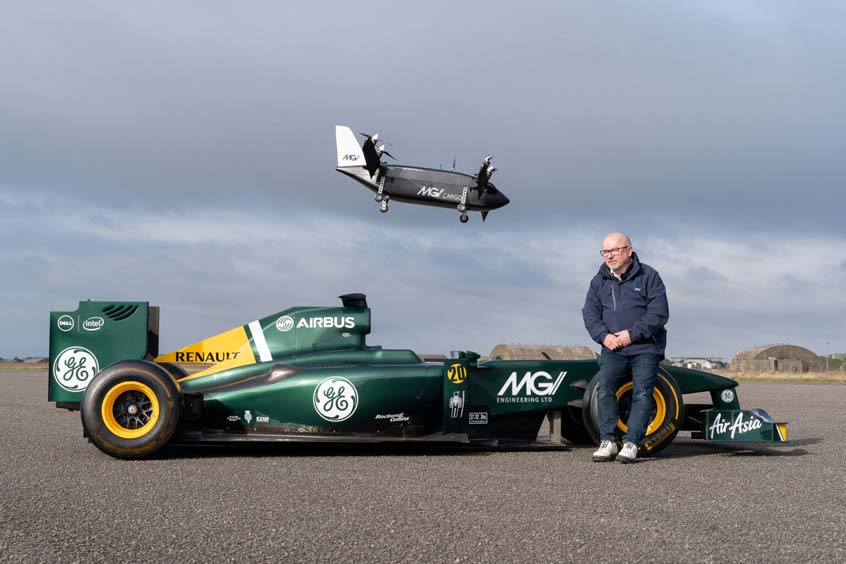 CEO Mike Gascoyne with MGI Engineering’s Mosquito cargo eVTOL and Formula 1 car.