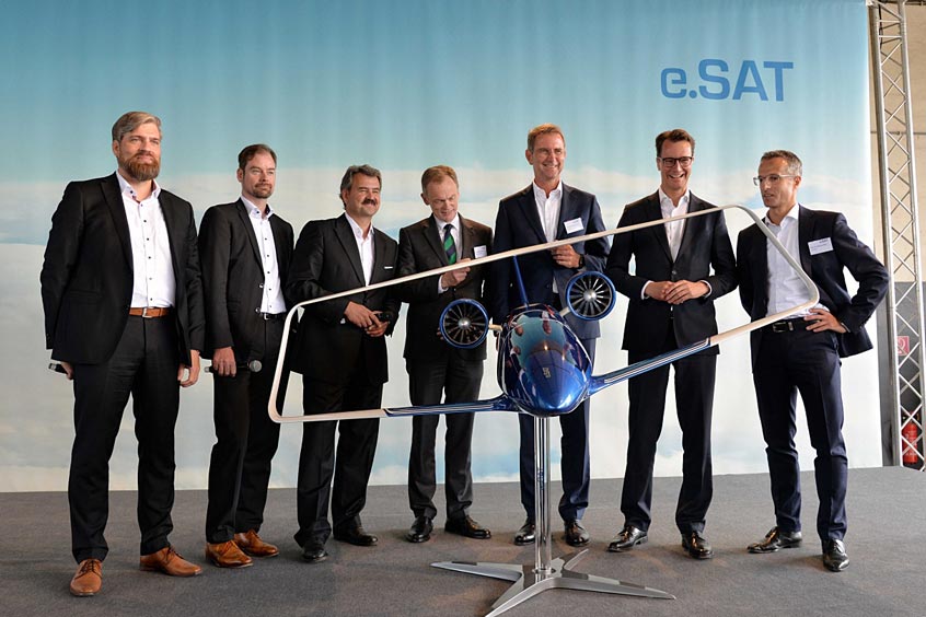 Unveiling of the Silent Air Taxi model: left to right: Prof. Dr. Kai-Uwe Schrö-der (e.SAT GmbH), Prof. Dr. Eike Stumpf (e.SAT GmbH), Prof. Dr. Frank Janser (e.SAT GmbH), Dr. Hendrik Schulte (State secretary, Ministry of Transport of the Federal State of North Rhine-Westphalia), Prof. Dr. Günther Schuh (e.SAT GmbH), Hendrik Wüst (Minister of Transport of the Federal State of North Rhine-Westphalia) and Prof. Dr. Peter Jeschke (e.SAT GmbH)