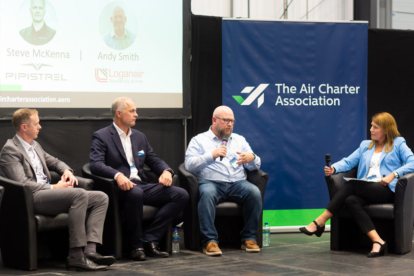 ZeroAvia head of external affairs and marketing Dominic Weeks, Pipistrel director of sales and marketing Steve McKenna and Loganair head of sustainability strategy Andy Smith talk zero emissions with moderator Rachel Gardner-Poole of the Jet Zero Council at ACE'23.