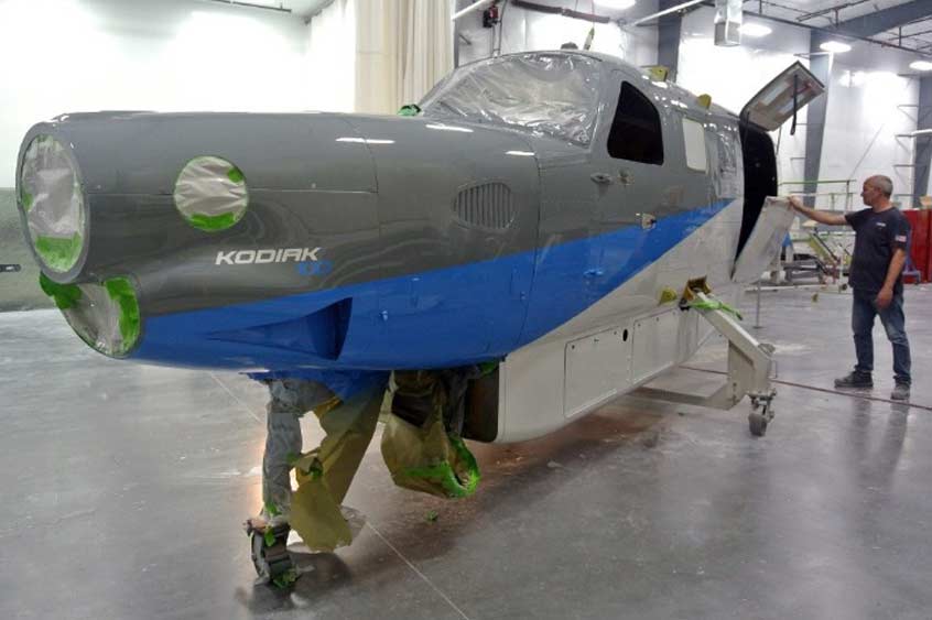 A Kodiak 100 fuselage is inspected after being painted in the new paint facility at Daher's facility in Sandpoint, Idaho.