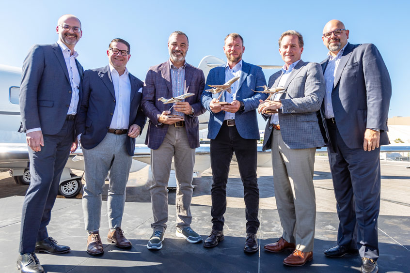 Bombardier EVP, aircraft sales Jean-Christophe Gallagher; Bombardier president and CEO Éric Martel; AB Jets co-owner director of operations David Turner and co-owner Andrew Bettis; IMC chairman Mark George; and Bombardier VP, sales - US Frank Vento.