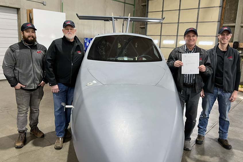 Sam Bousfield (holding patent document) and Samson in-house engineering team. The Switchblade flying sports car is the first of its kind. is a three-wheel, street legal vehicle that you drive from your garage to a nearby local airport. Once there, the wings swing out and the tail extends in under 3 minutes. You then fly your registered aircraft directly to the destination - at up to 200 mph and 13,000 feet.