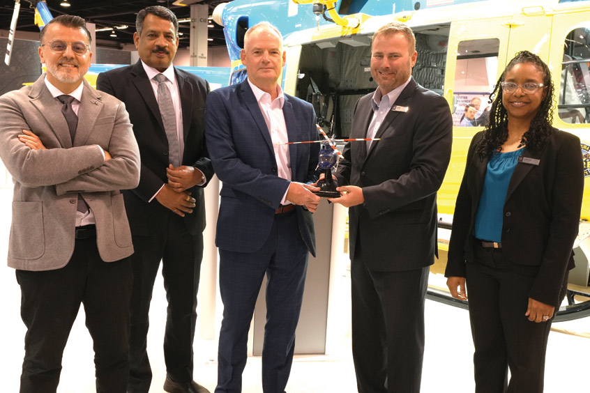 The Abu Dhabi Aviation team celebrates its CSF agreement with, on the right, Bell VP global customer solutions Chris Schaefer and VP sales LaShan Bonaparte.