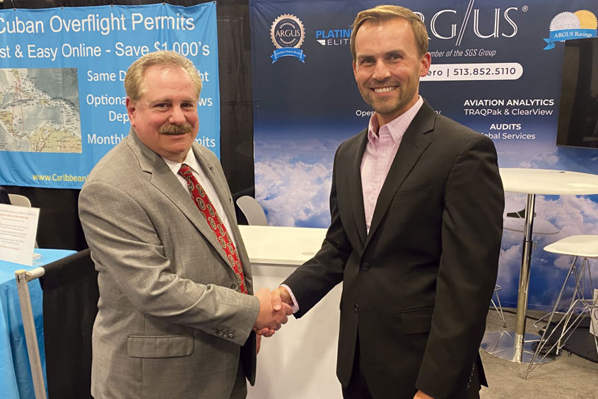 Mosaix president and CEO David Castaldo shakes hands with ARGUS SVP software Travis Kuhn of ARGUS on a partnership for TRAQPak FBO subscribers at SDC2024. 
