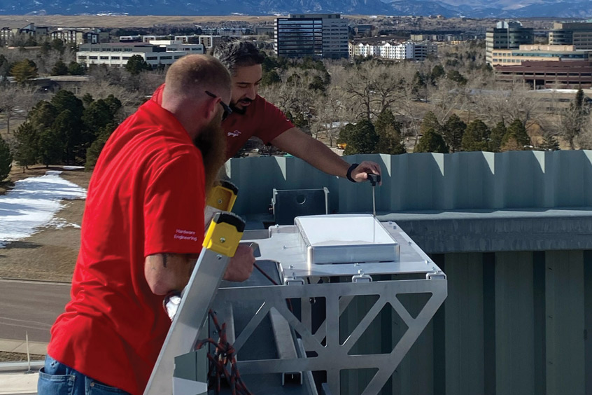 Technicians instal the Gogo Galileo HDX antenna prototype now being used for initial testing on the roof of Gogo's headquarters in Broomfield, Colorado.