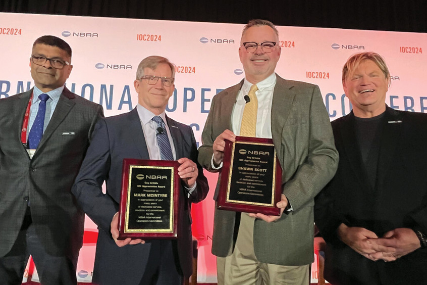 Mark McIntyre, CAM fellow and director of flight operations at Mente and Shawn Scott, co-founder of Scott IPC with their NBAA Guy Gribble appreciation awards.