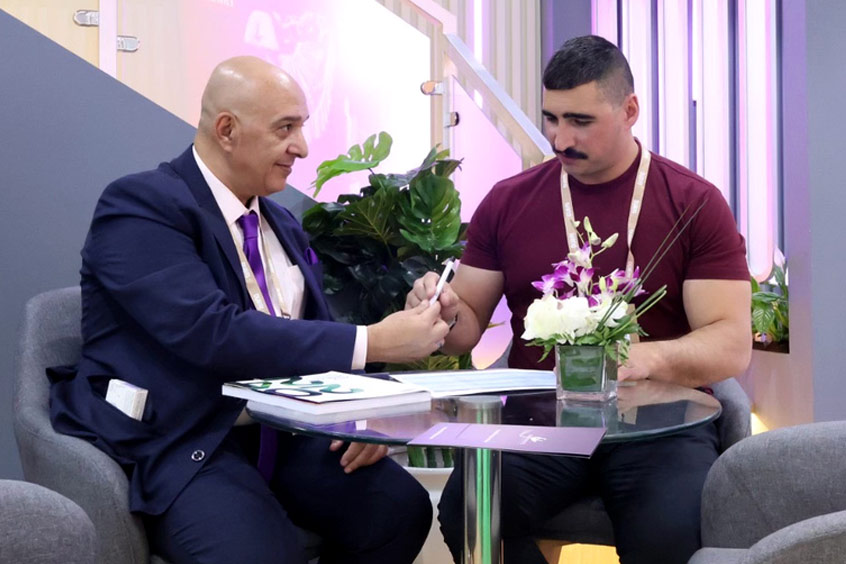 Mayfair Jets co-founder and chairman Ahmed Elhawary MBE signs with Global Air Charters CEO Michael Vanacore-Netz at the Arabian Travel Market in Dubai.