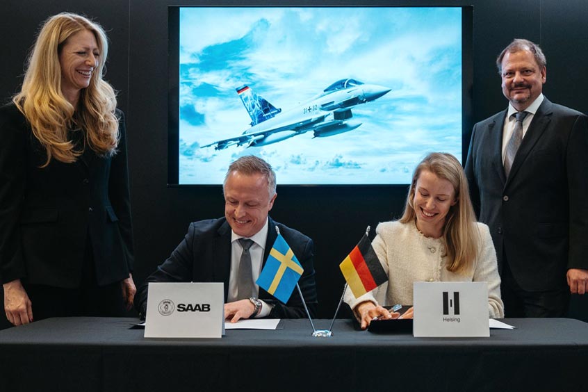 Executives from Helsing and Saab sign the contract, including signatories Matthias Amthor, Deputy CEO Saab Deutschland and Stephanie Lingemann, Senior Director Air Domain at Helsing with Dirk Brückner, Programme Manager Saab Deutschland GmbH.